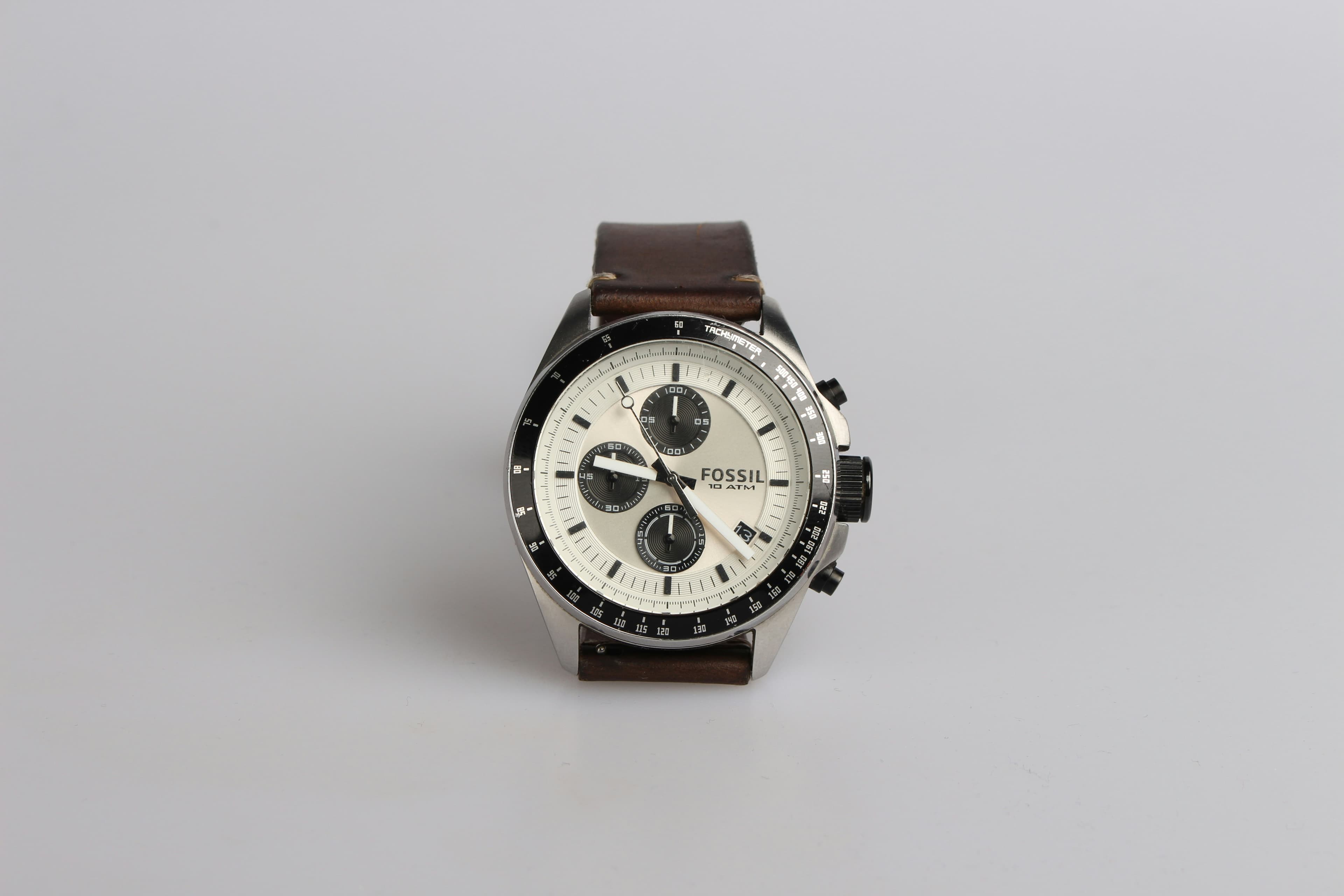 Gunmetal Fastrack chronograph watch with brown leather strap on white background