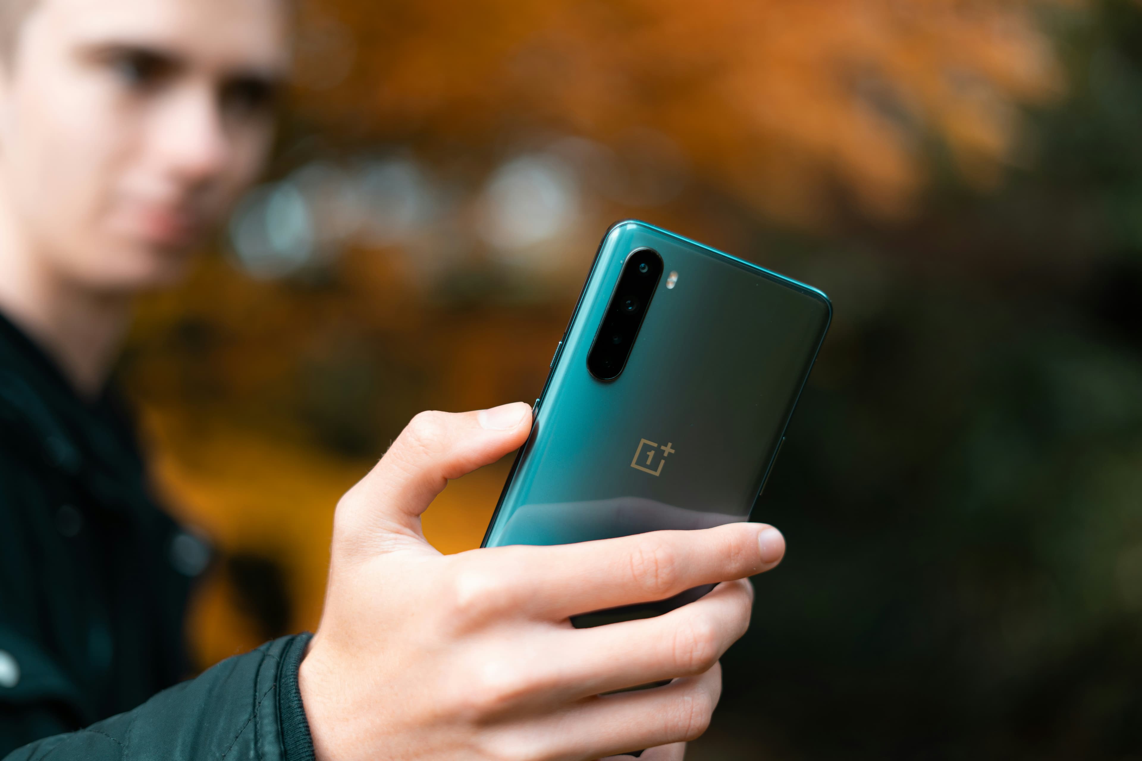 Pastel lime green OnePlus smartphone showing home screen